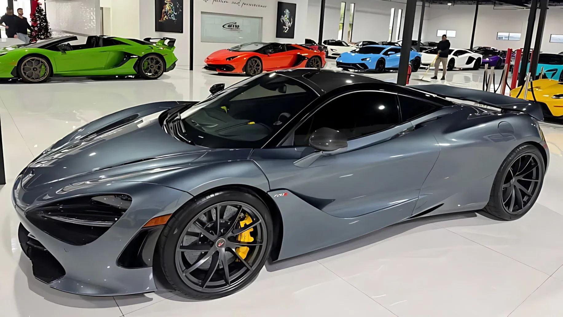Metallic gray 2018 McLaren 720S with yellow calipers in a vibrant showroom amid other exotics, premium best supercars under 0k