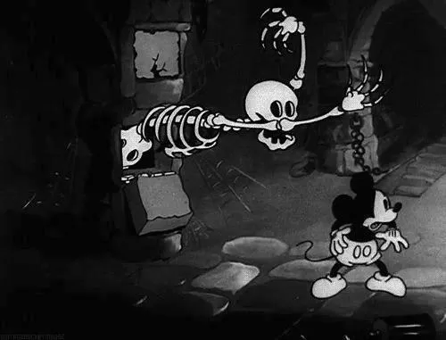Mickey Mouse in classic black and white, looking mischievous and fun