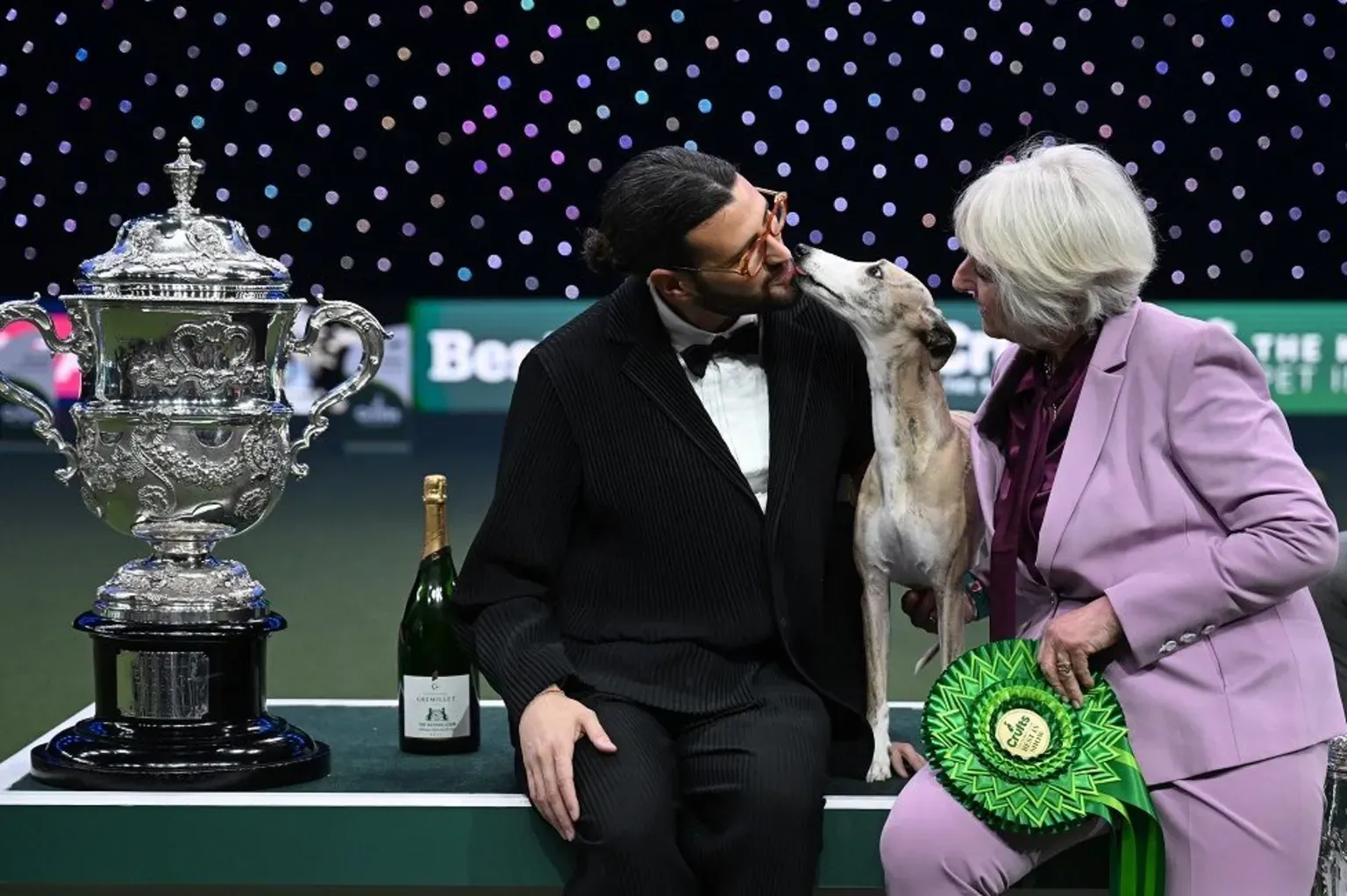Miuccia, a whippet, poses with owner Giovanni Liguori, from Italy, and judge Patsy Hollings