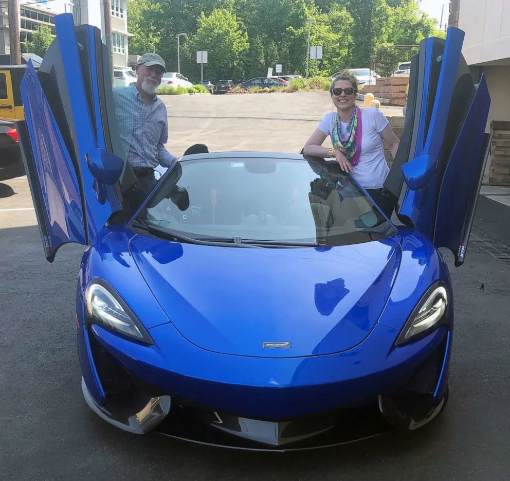 Morgan Korn and her father Buz Korn posing with a McLaren 570S Spider