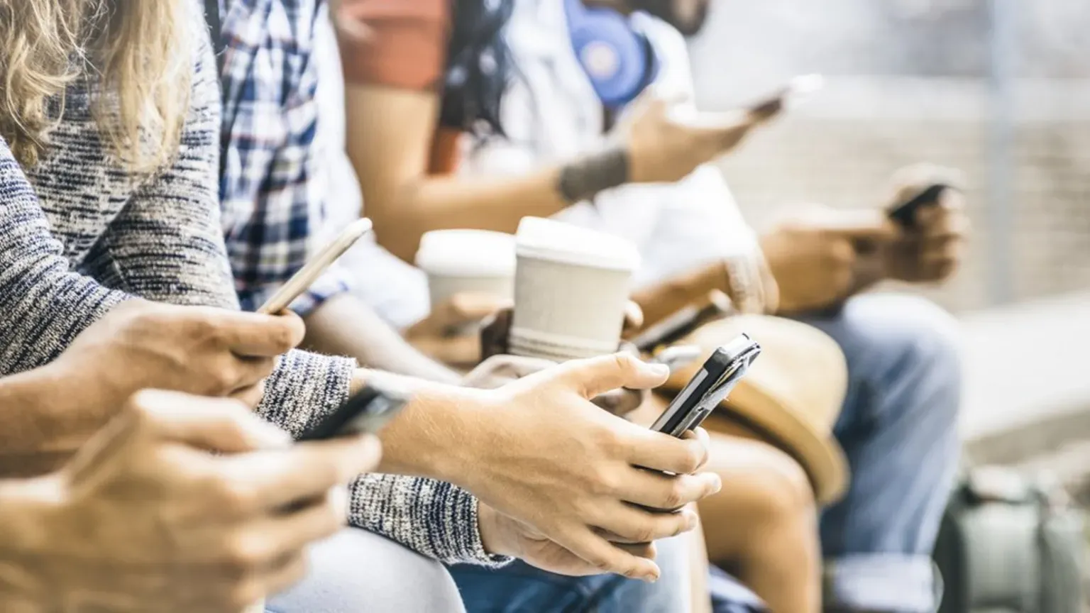 People using smartphones, symbolizing reliance on online information