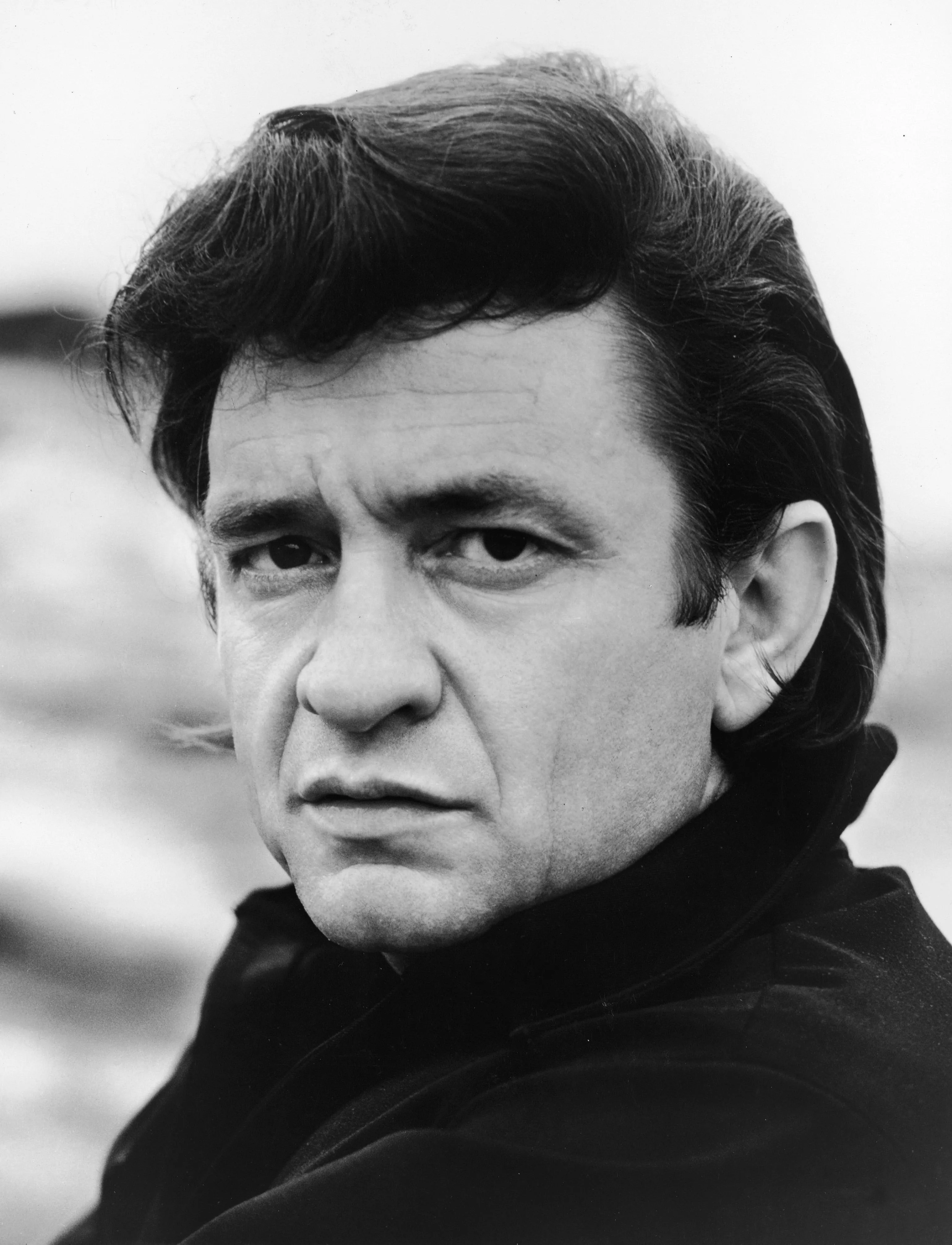 Promotional headshot portrait of American country singer Johnny Cash.