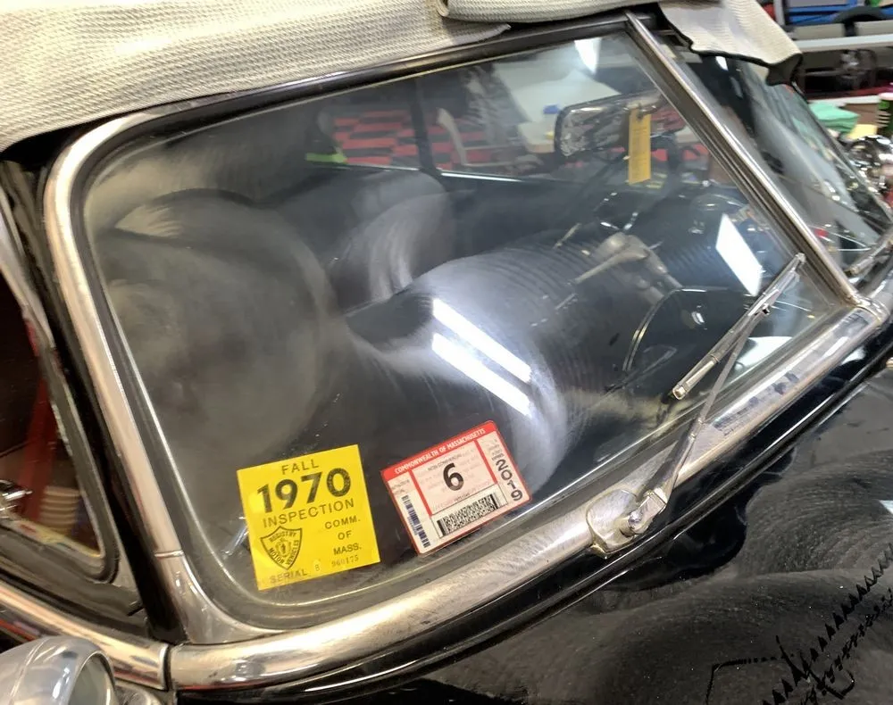 Reflection on the restored paintwork of the classic Pontiac.