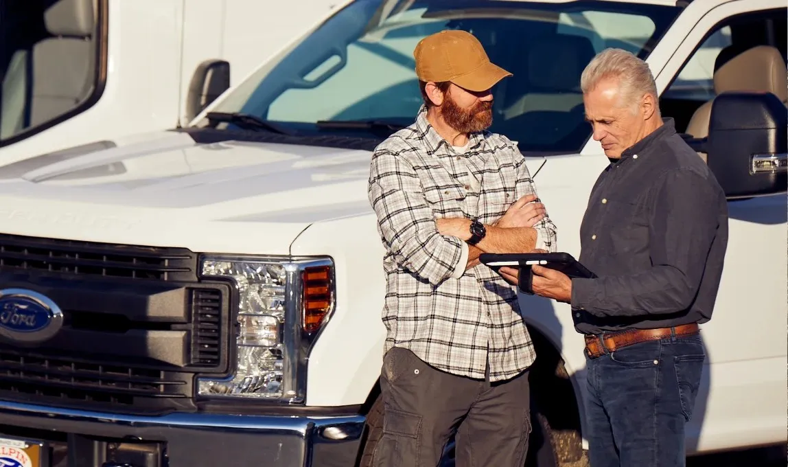 Safety manager discussing report with driver