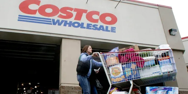 Shoppers browsing pet food aisles at a warehouse club