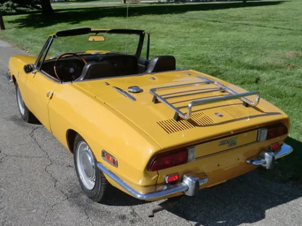 Side profile of the elegant Bertone design of a vintage Fiat Spider