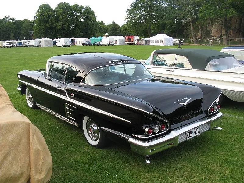 Side view of a classic 1958 Chevrolet Impala parked outdoors