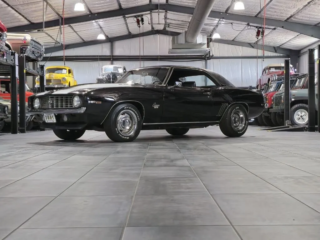 Side view of a classic 1969 Chevrolet Camaro in black, showcasing its timeless design
