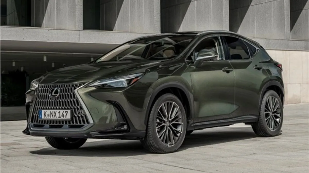 Side view of a silver Lexus NX 350h driving on a road