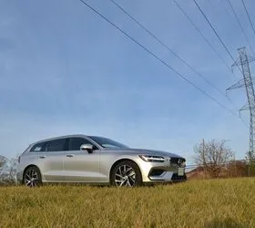 Side view of the 2020 Volvo V60 T8 on a winding road, demonstrating its handling capabilities