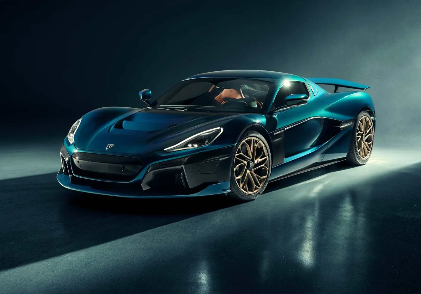 Silver Rimac Nevera electric hypercar parked on a road at sunset