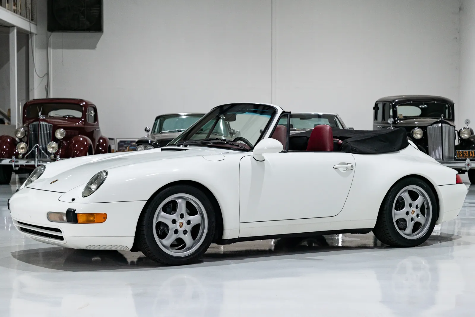 Sleek 1995 Porsche 911 Carrera Cabriolet with its soft top down, captured on a sunny day