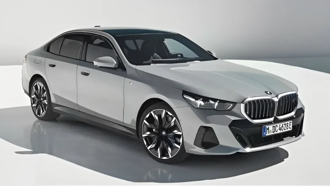 Sleek black 2024 BMW i5 eDrive40 Sedan parked with modern architecture in the background