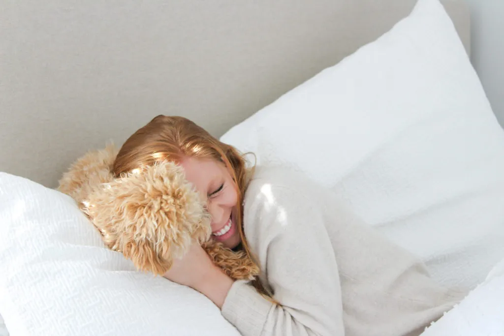Snuggling with Ranger, my apricot Maltipoo puppy in bed.