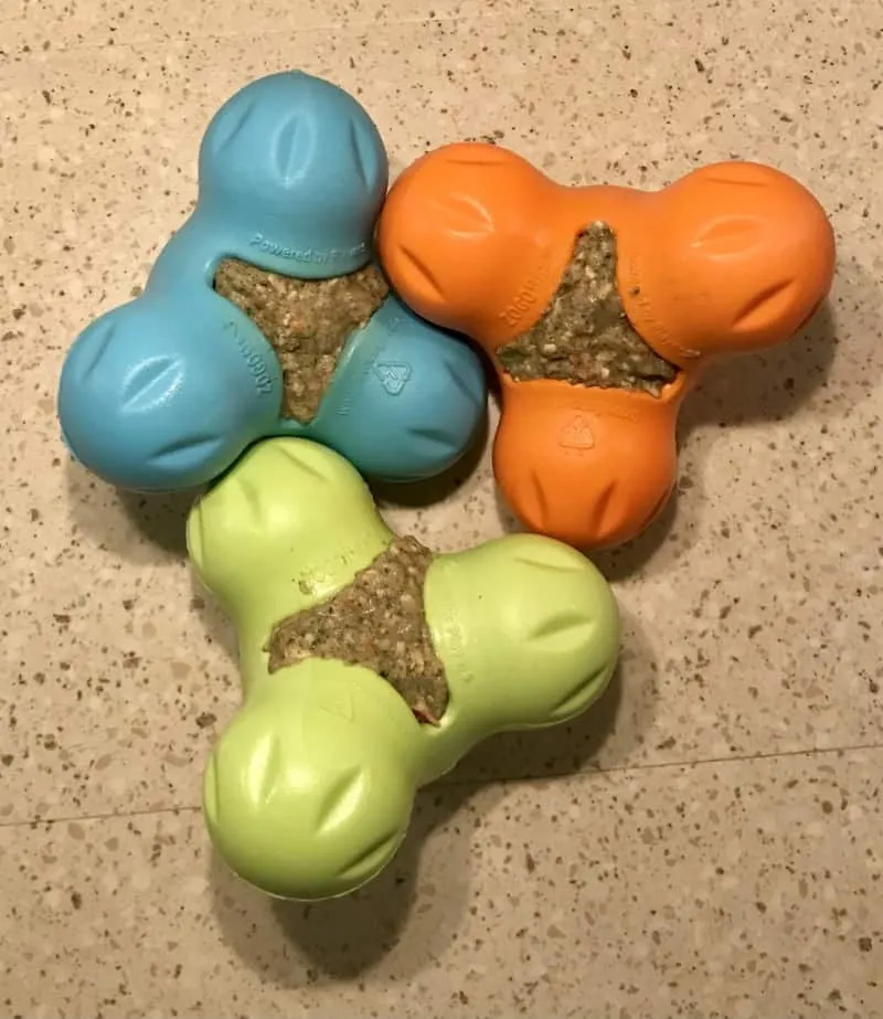 Stuffed West Paw toys with dehydrated food ready for freezing