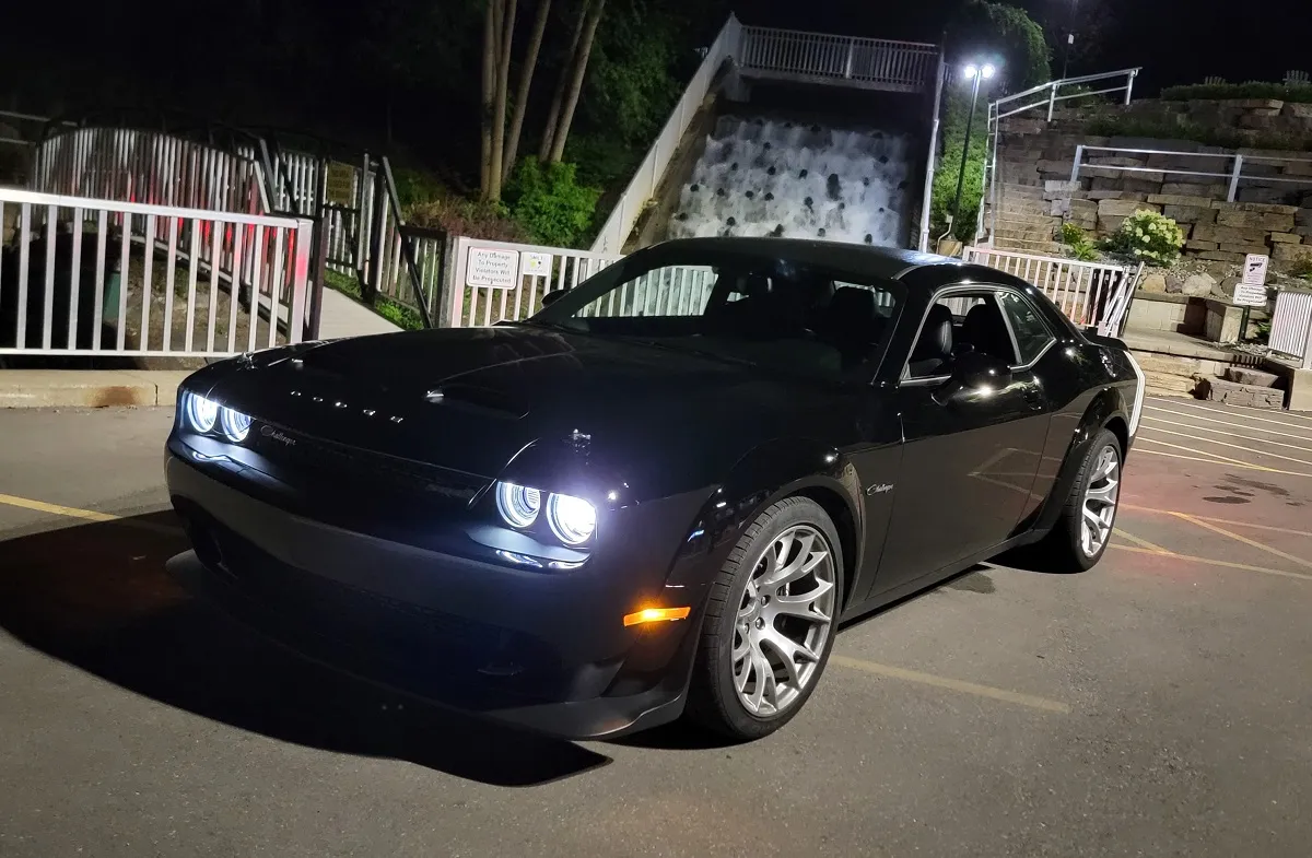 The 2023 Dodge Challenger Black Ghost accelerating, showcasing the rear tires under stress as it launches forward.