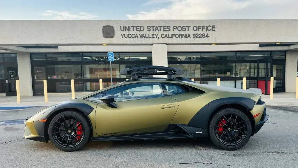 The 2024 Lamborghini Huracán Sterrato parked outdoors, showcasing its unique matte green finish and roof rack.