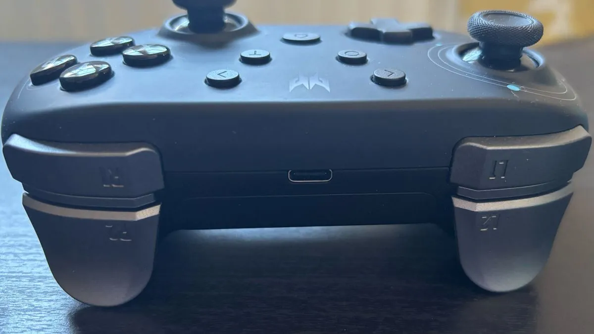 The Acer Predator controller shown with its 2.4GHz dongle partially extracted from its battery compartment