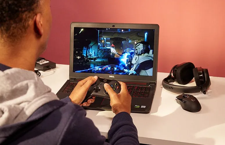 The black lid of the Dell Inspiron 15 5000 gaming laptop with a subtle red Dell logo.