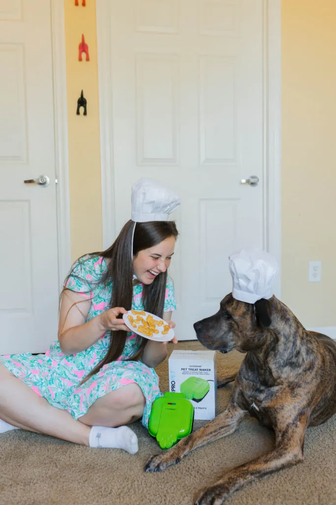 The CONAIRPROPET GoodBone Dog Treat Maker in action, surrounded by a clean and bright aesthetic.