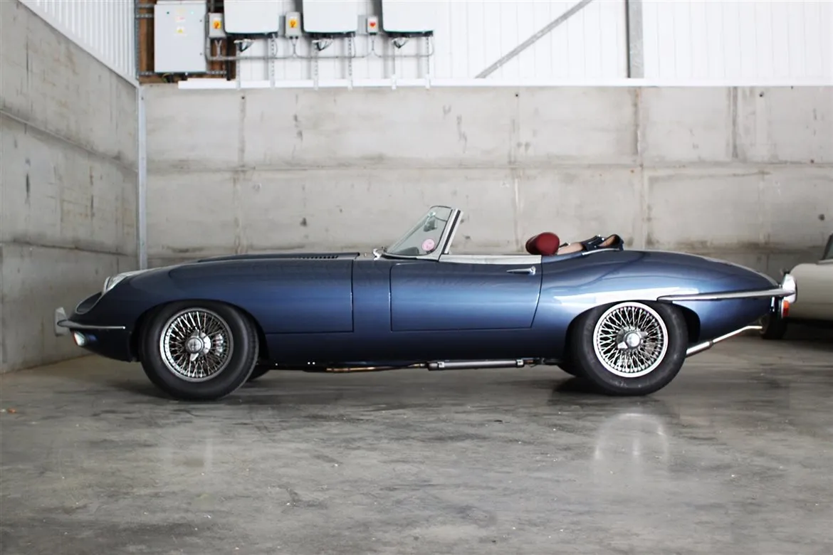 The distinctive front fascia of a Jaguar E-Type Series 2, highlighting its uncovered headlamps and revised grille.