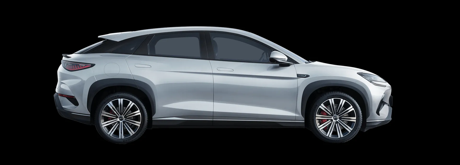 The elegant silver BYD Sealion 7 electric SUV parked outdoors with modern architecture in the background