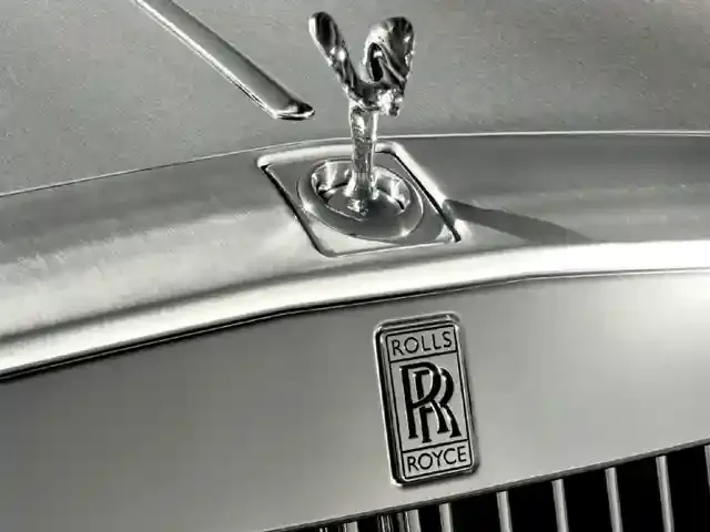 The iconic Spirit of Ecstasy mascot on the grille of a Rolls-Royce