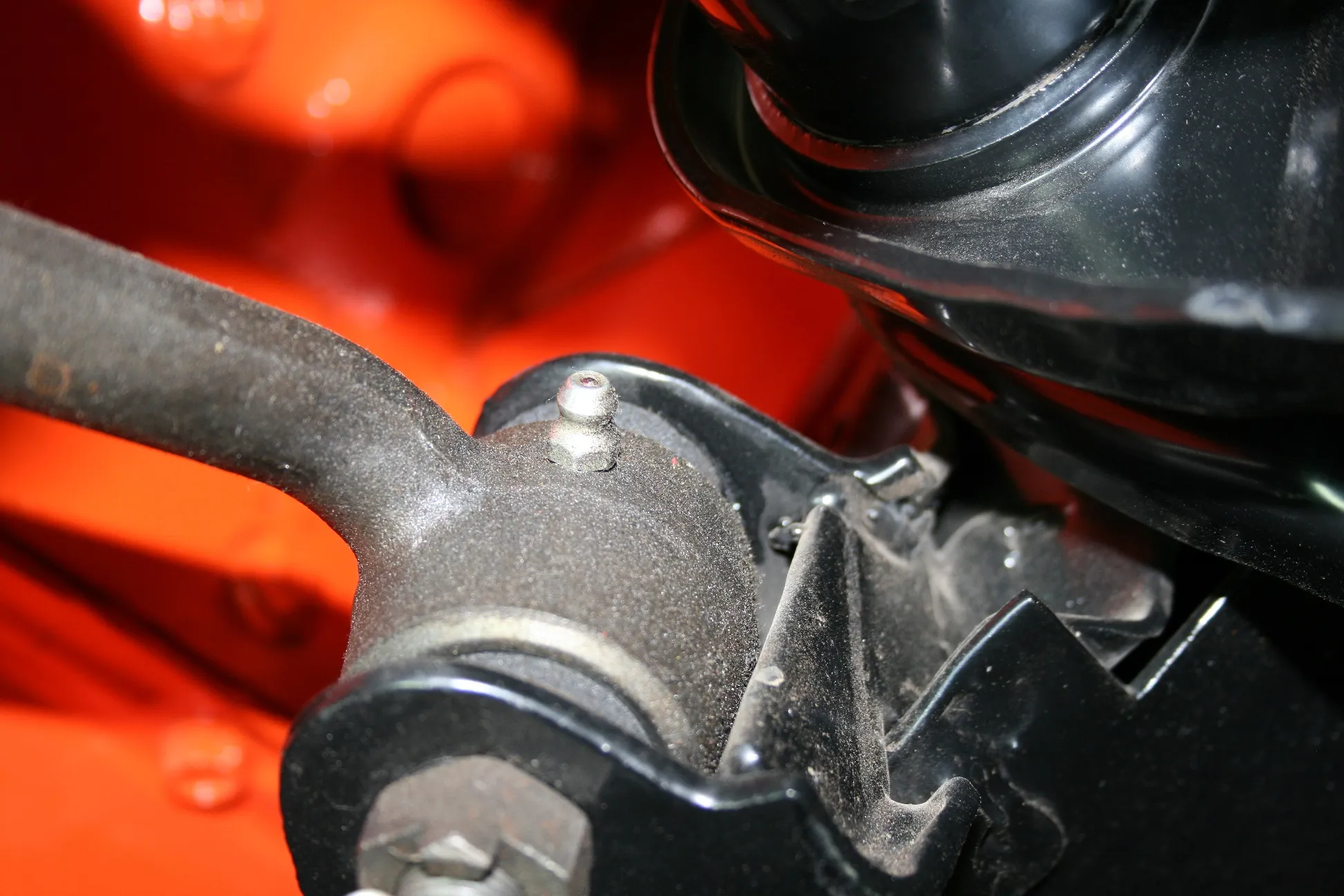 The idler arm with a grease fitting