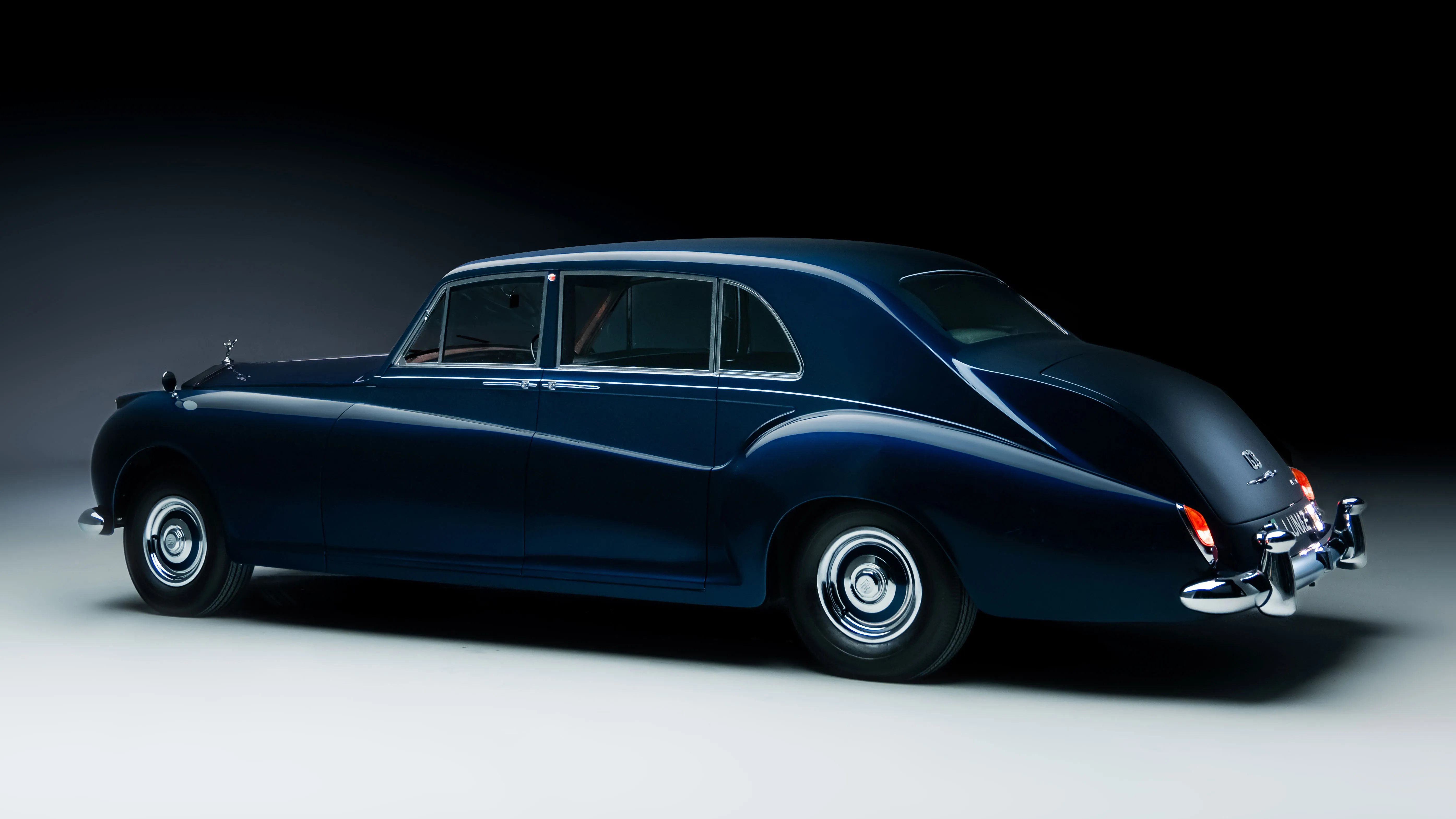 The interior features a blend of classic design and modern technology, including a sophisticated infotainment system.