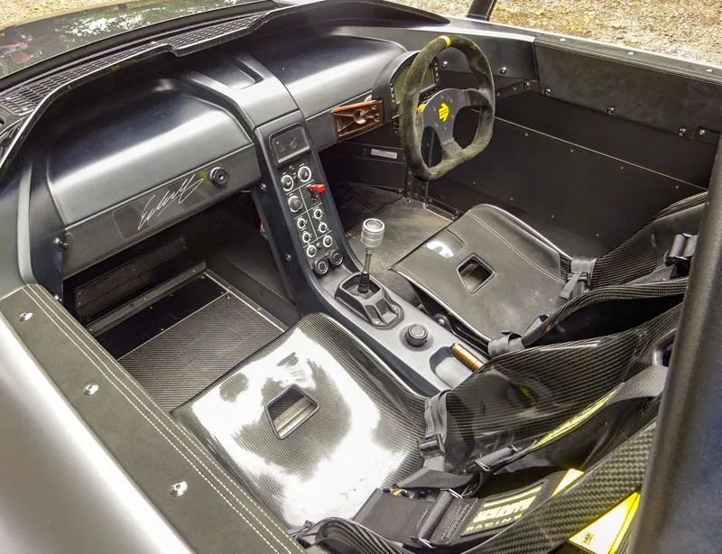 The minimalist and functional interior of the VUHL 05, featuring carbon fibre seats and a digital display