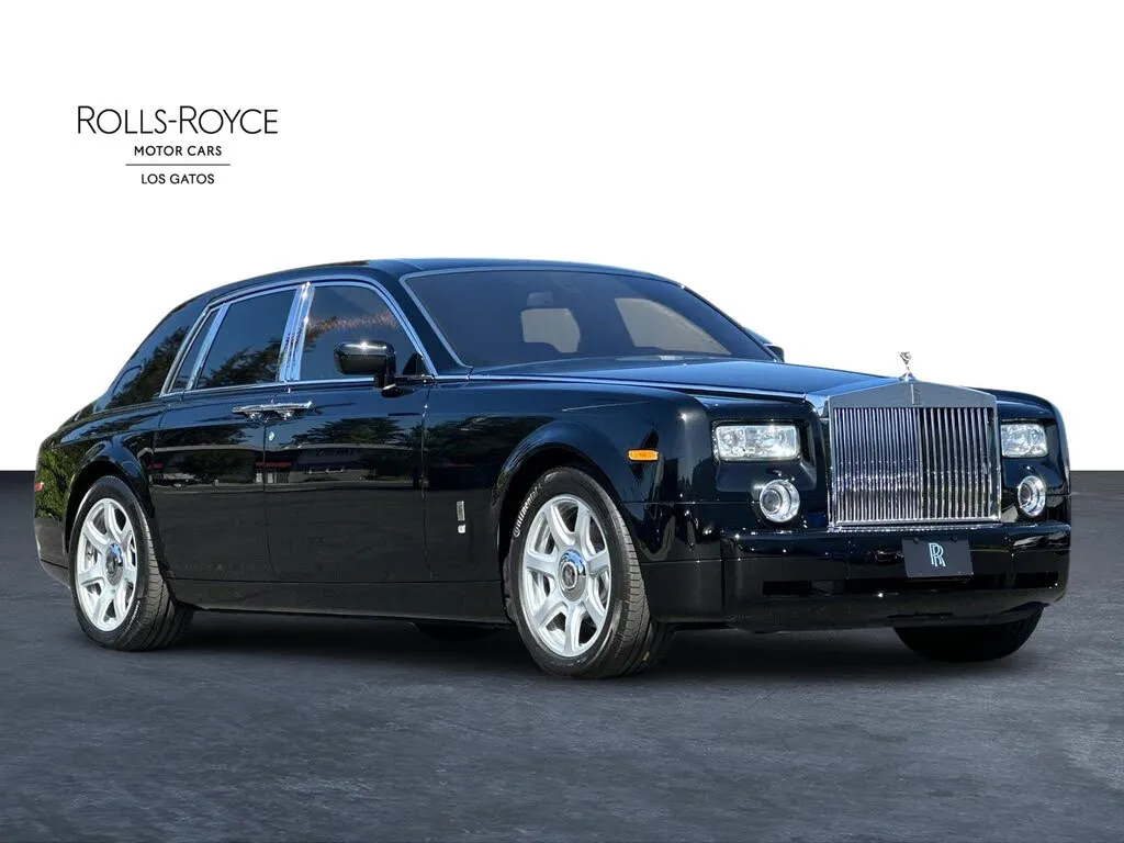 The opulent interior of a 2008 Rolls-Royce Phantom, showcasing the premium leather, wood veneers, and polished metal accents.
