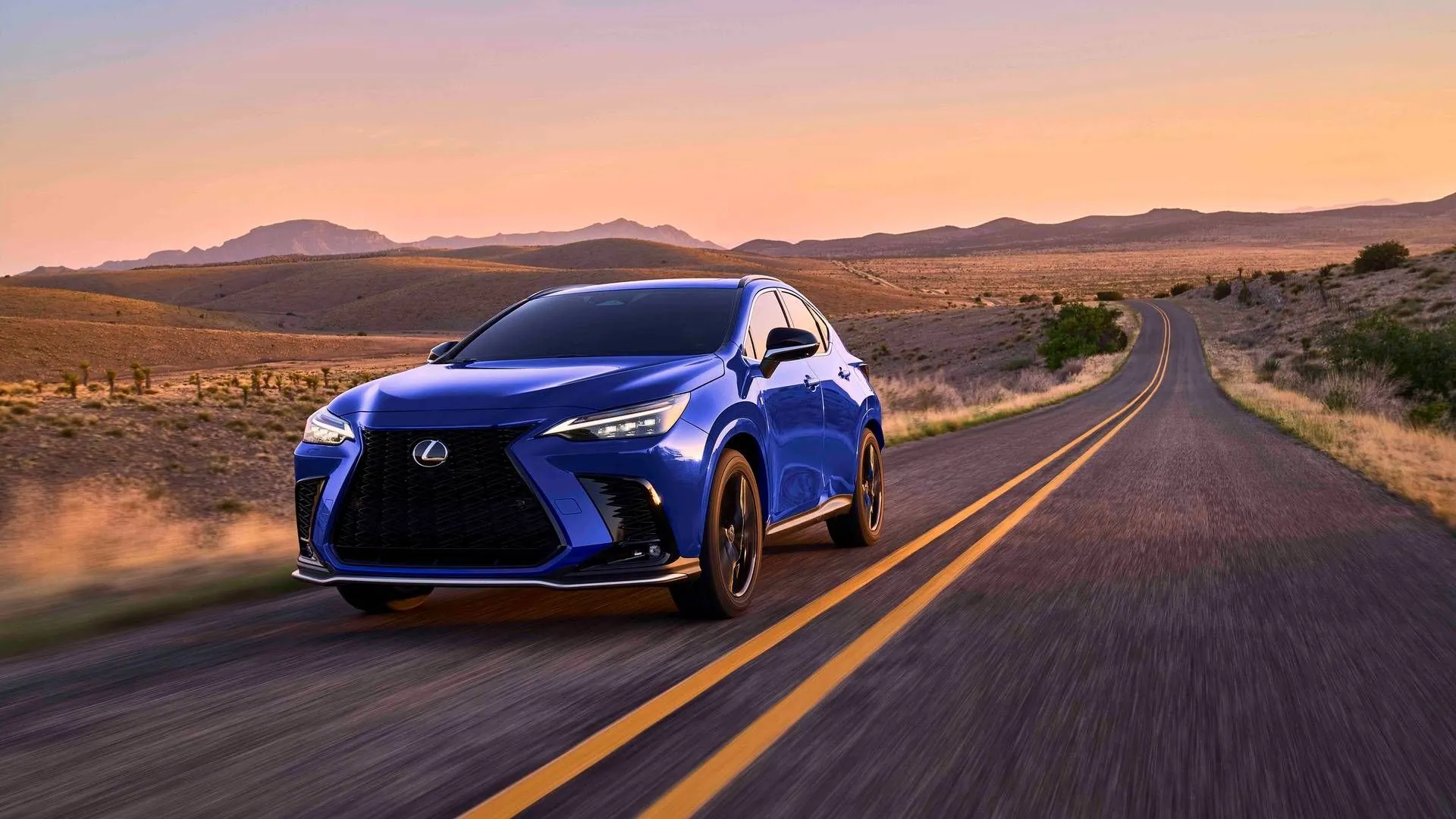The sleek front design of the 2025 Lexus NX Plug-In Hybrid on the road.