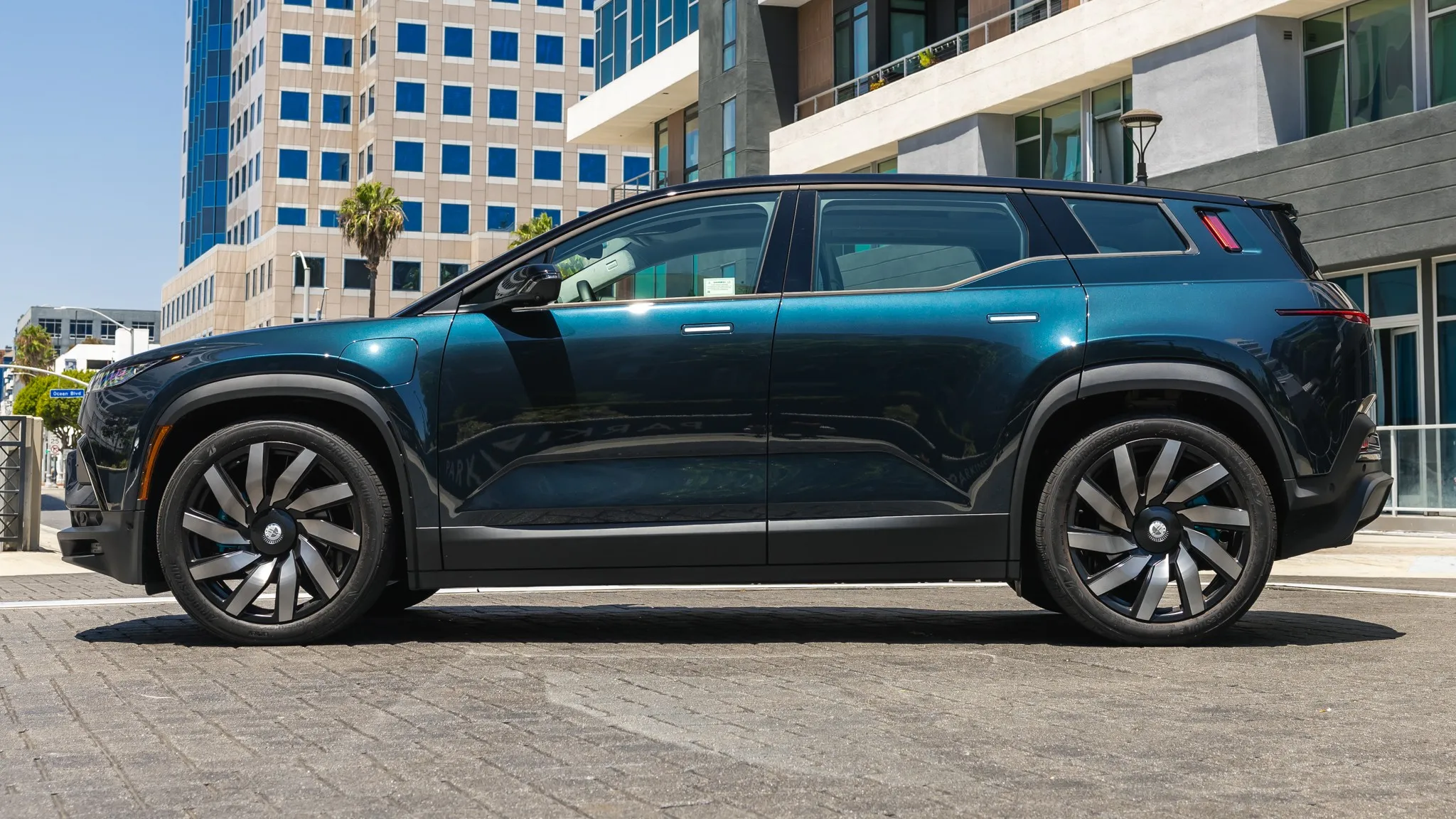 The sleek profile of the Fisker Ocean SUV, highlighting its hot hatch-like proportions and large wheels.