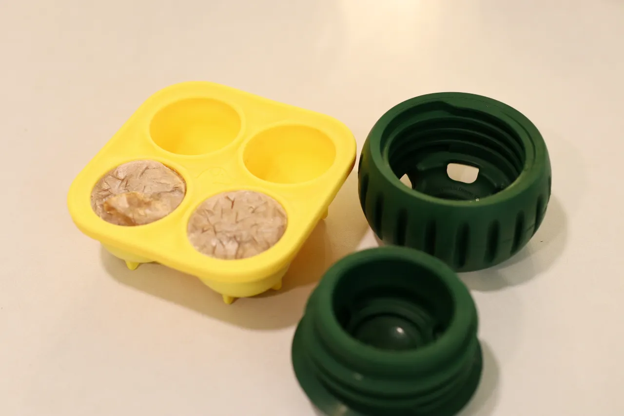The treat tray and open Woof Pupsicle sits on counter