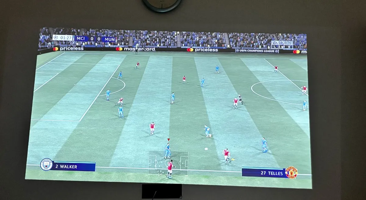 Xgimi Halo Plus mini projector actively projecting a gaming interface onto a wall