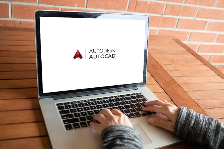 Young professional working on a laptop using Autodesk software AutoCad.