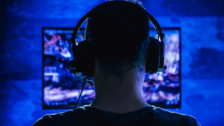 A person playing a video game, with a look of intense focus.