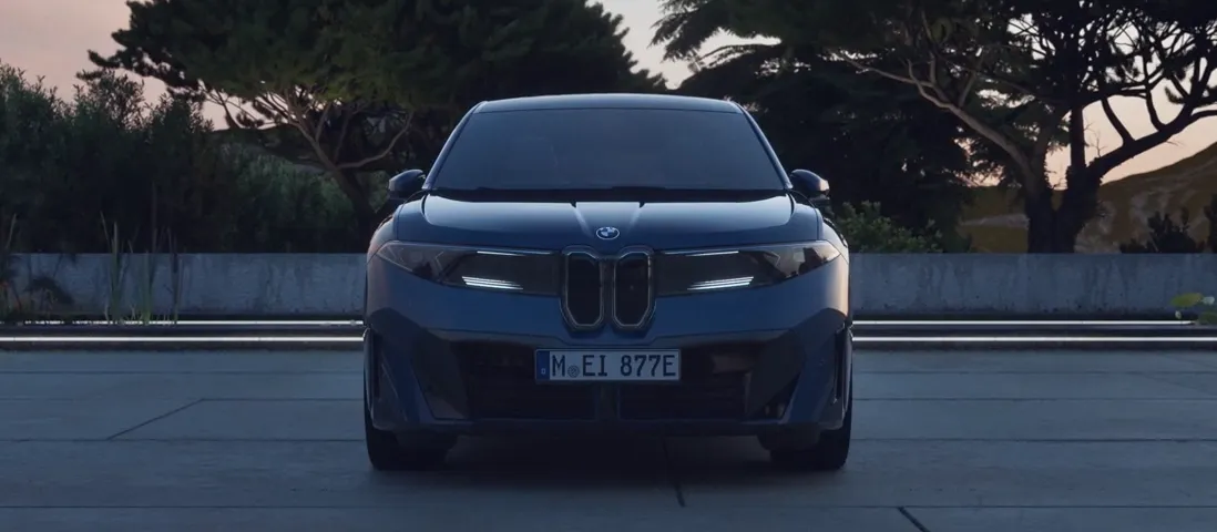 Front view of a modern electric BMW sedan with sleek LED headlights and bold kidney grille.