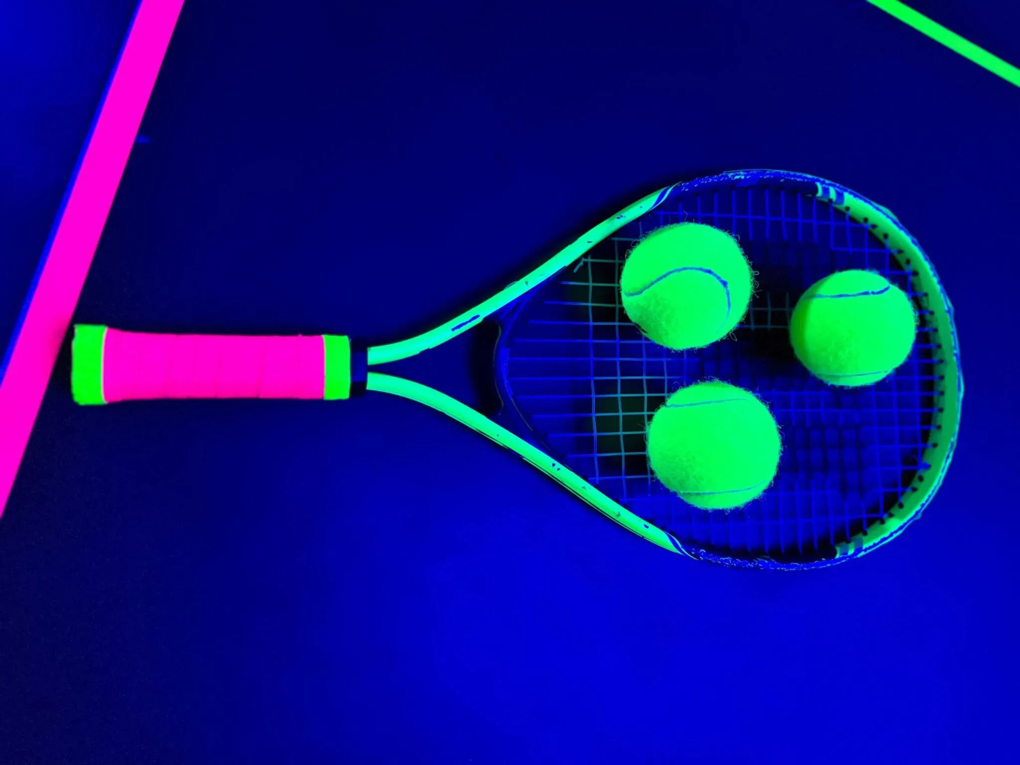 Glow tennis racket with neon tape