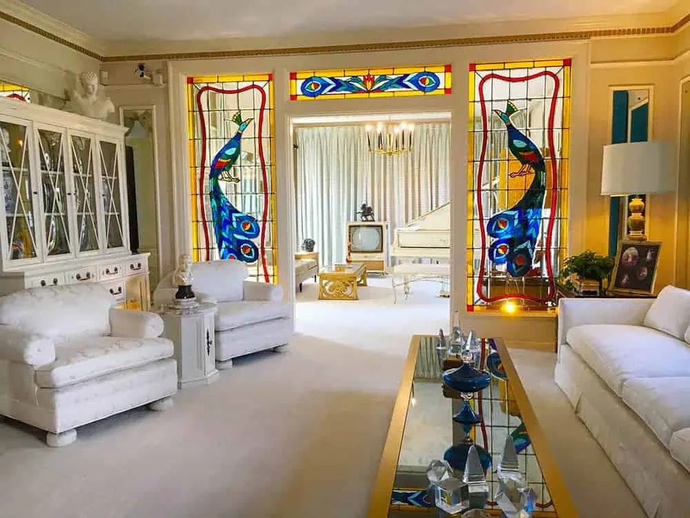 The white lounge and TV room at Graceland, featuring Elvis’s grand piano.