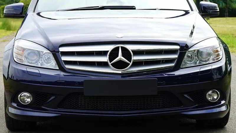 A selection of reliable used luxury cars under $20,000 are displayed, showcasing their premium exteriors.