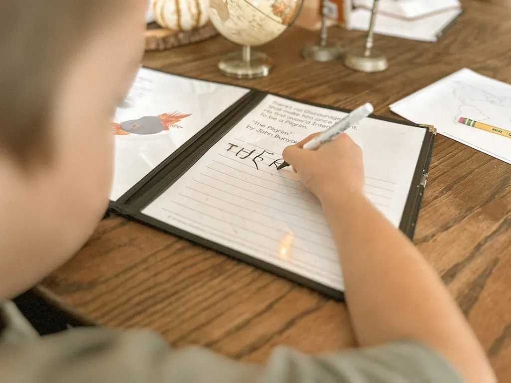 Copywork practice using lined paper inside a menu cover