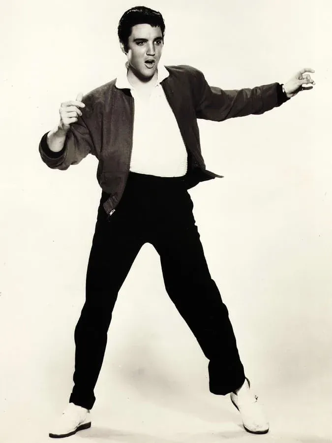 Elvis Presley in a polo shirt and bomber jacket