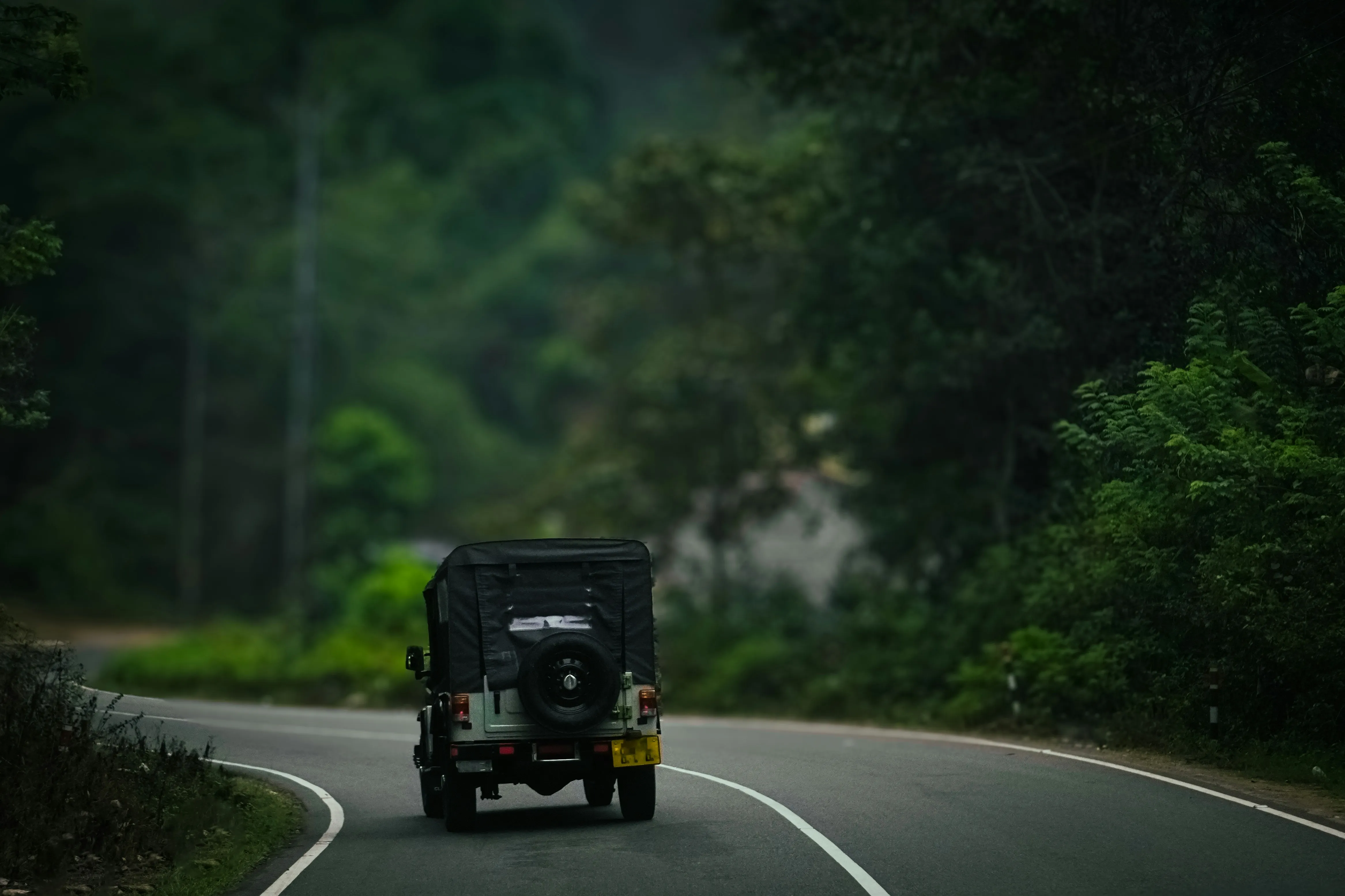 Luxury electric SUV driving along a scenic coastal highway