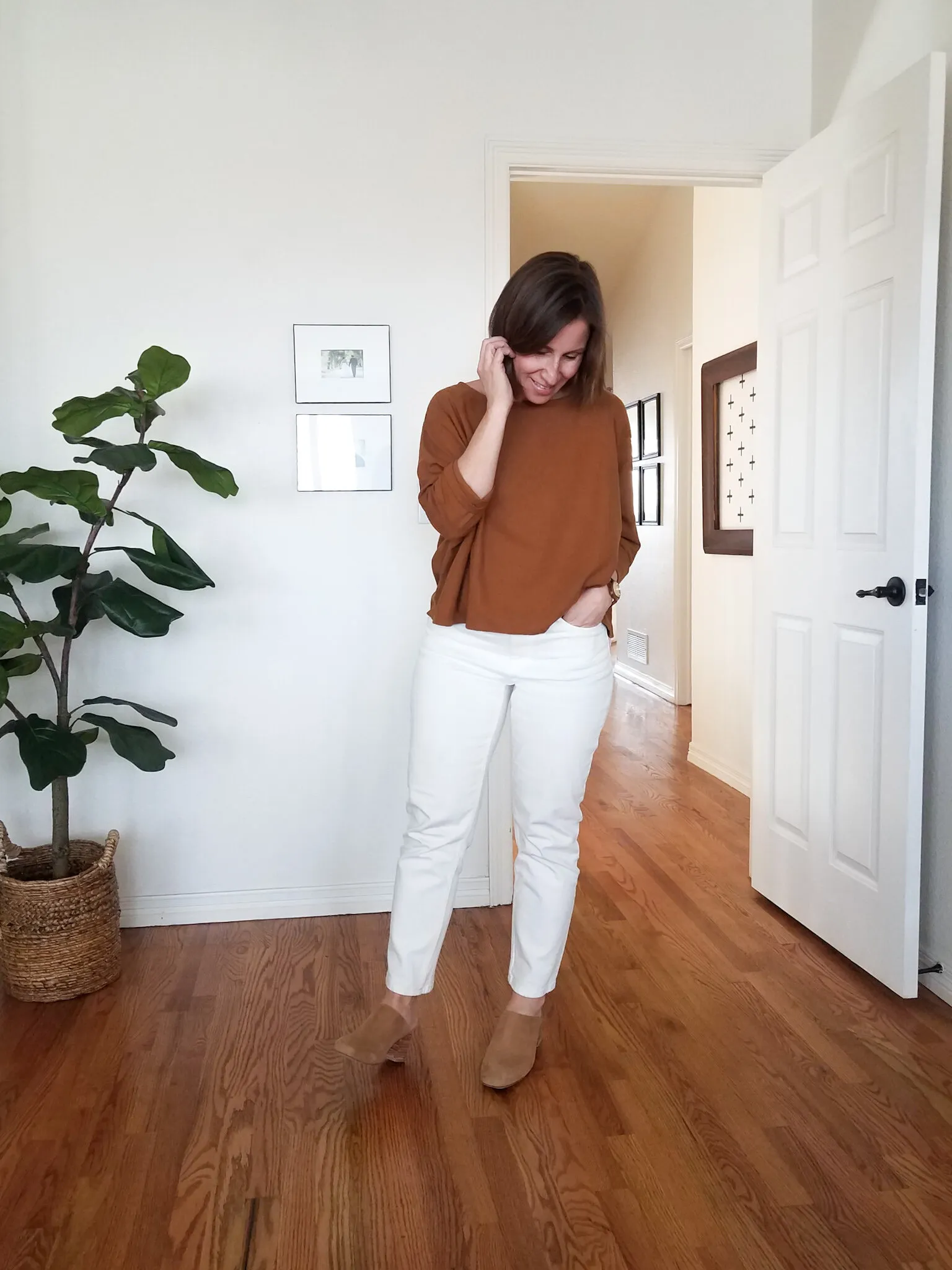 Paige Marchi in a light-colored outfit with similar silhouettes to the previous day