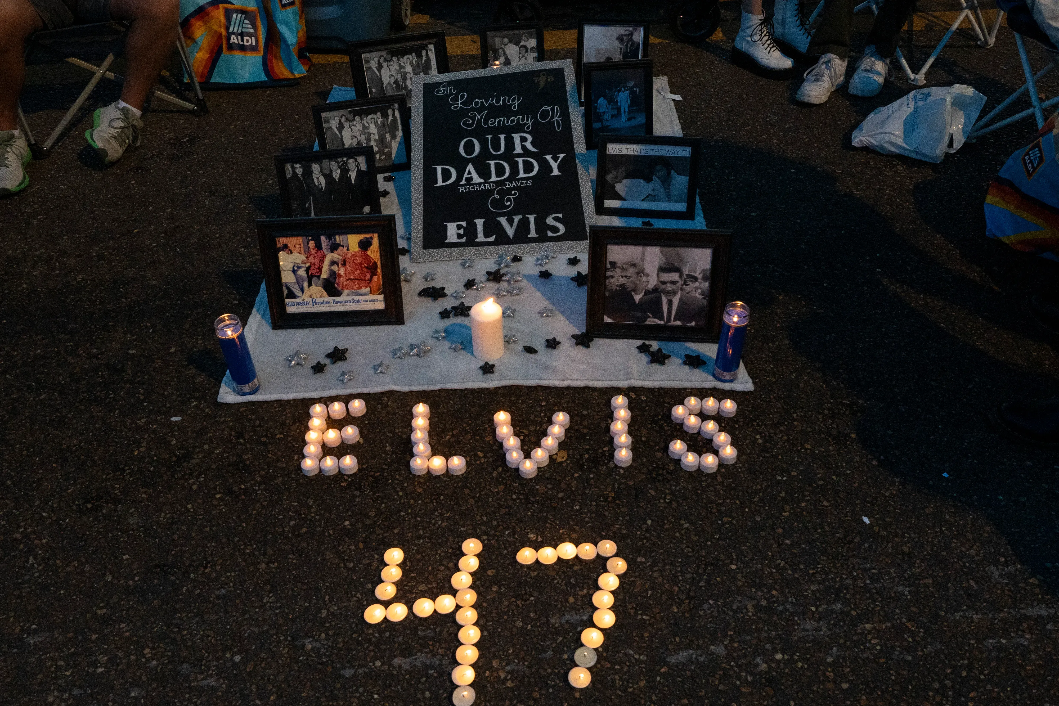 Fans gather outside Graceland for a vigil, holding candles to honor Elvis Presley on the anniversary of his death