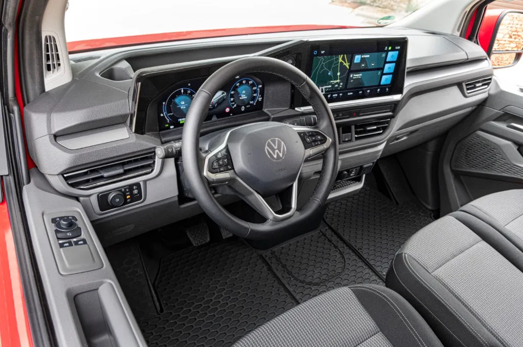 Driver and front passenger area of Volkswagen e-Transporter showing VW infotainment system