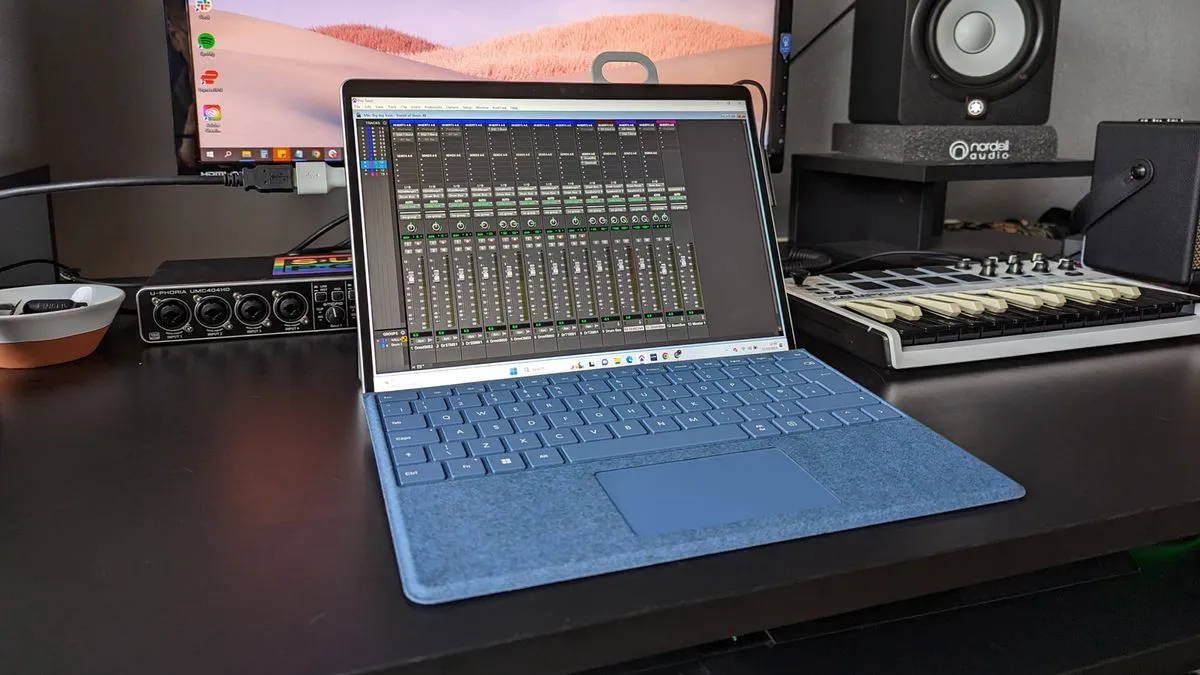A Microsoft Surface Pro 9 laptop on a music desk