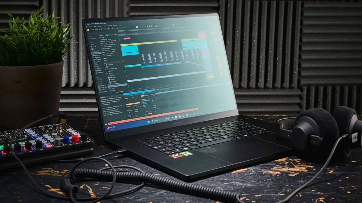 An Asus ProArt P16 laptop on a desk with music production gear