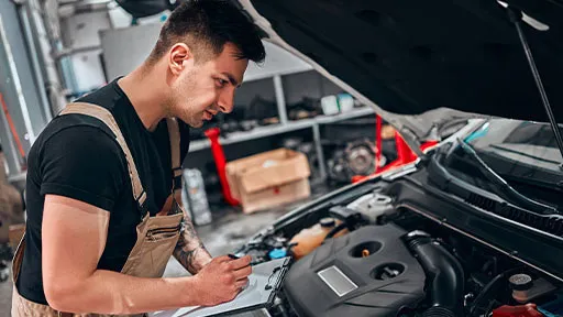 Mechanic checking car engine.
